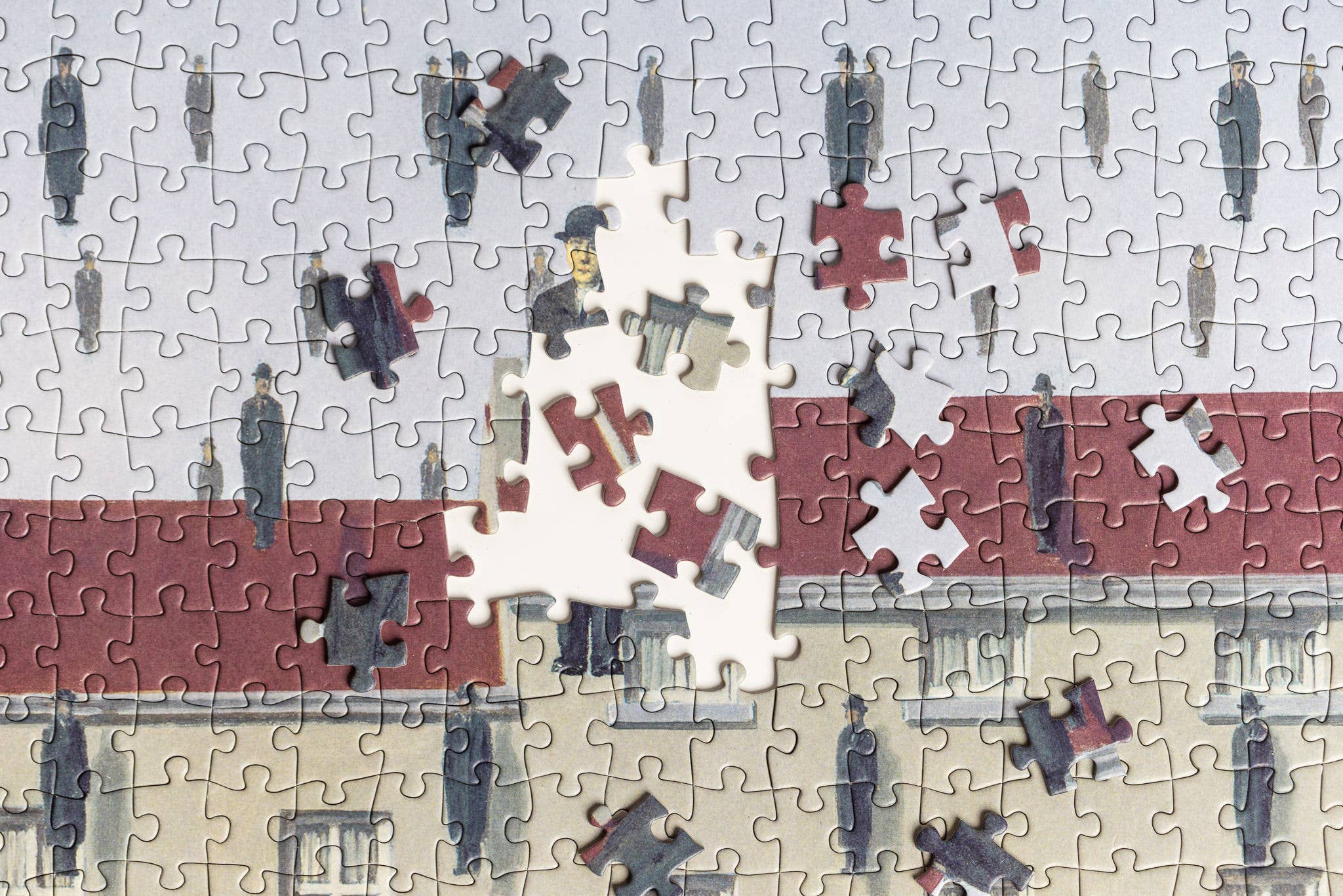 The Puzzle - René Magritte - Golconda, shows men in coats and hats with a building backdrop.