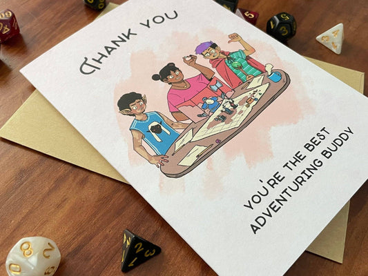 Handmade greeting card with cartoon characters gaming and the text “YOU’RE THE BEST ADVENTURING BUDDY.”.