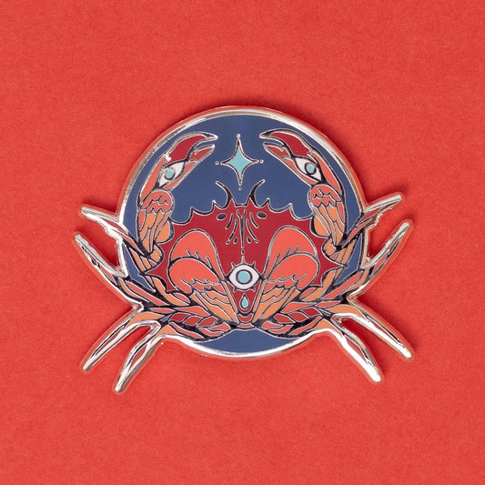 Silver-plated enamel pin featuring two red stylized crabs on a dark blue circular background.