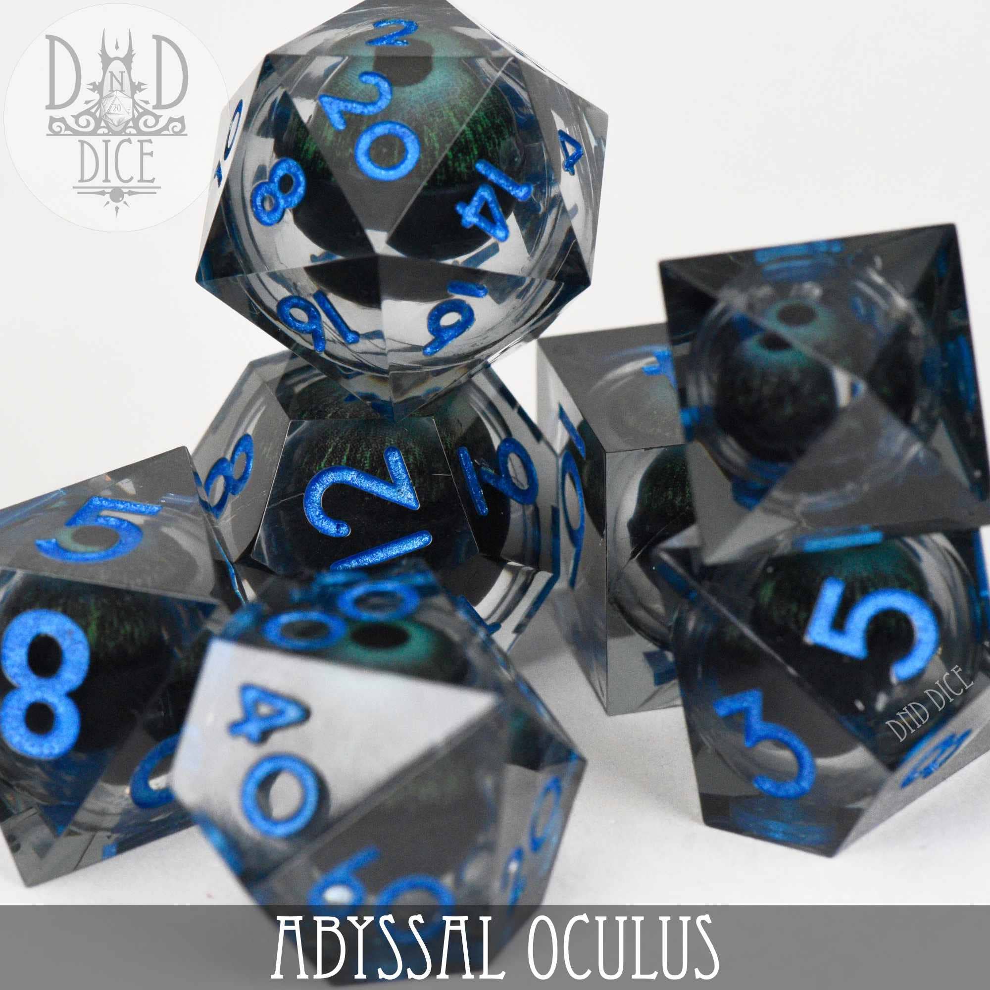 Abyssal Oculus liquid core dice: translucent grey with dark green eyeballs and metallic blue numbering.