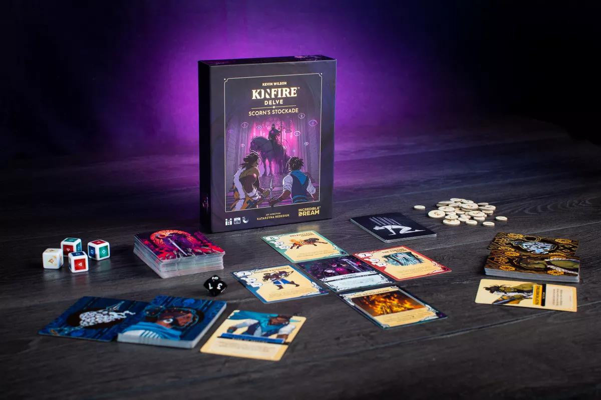 Kinfire Delve: Scorns Stockcade cooperative card game set with cards, tokens, dice, and game box.