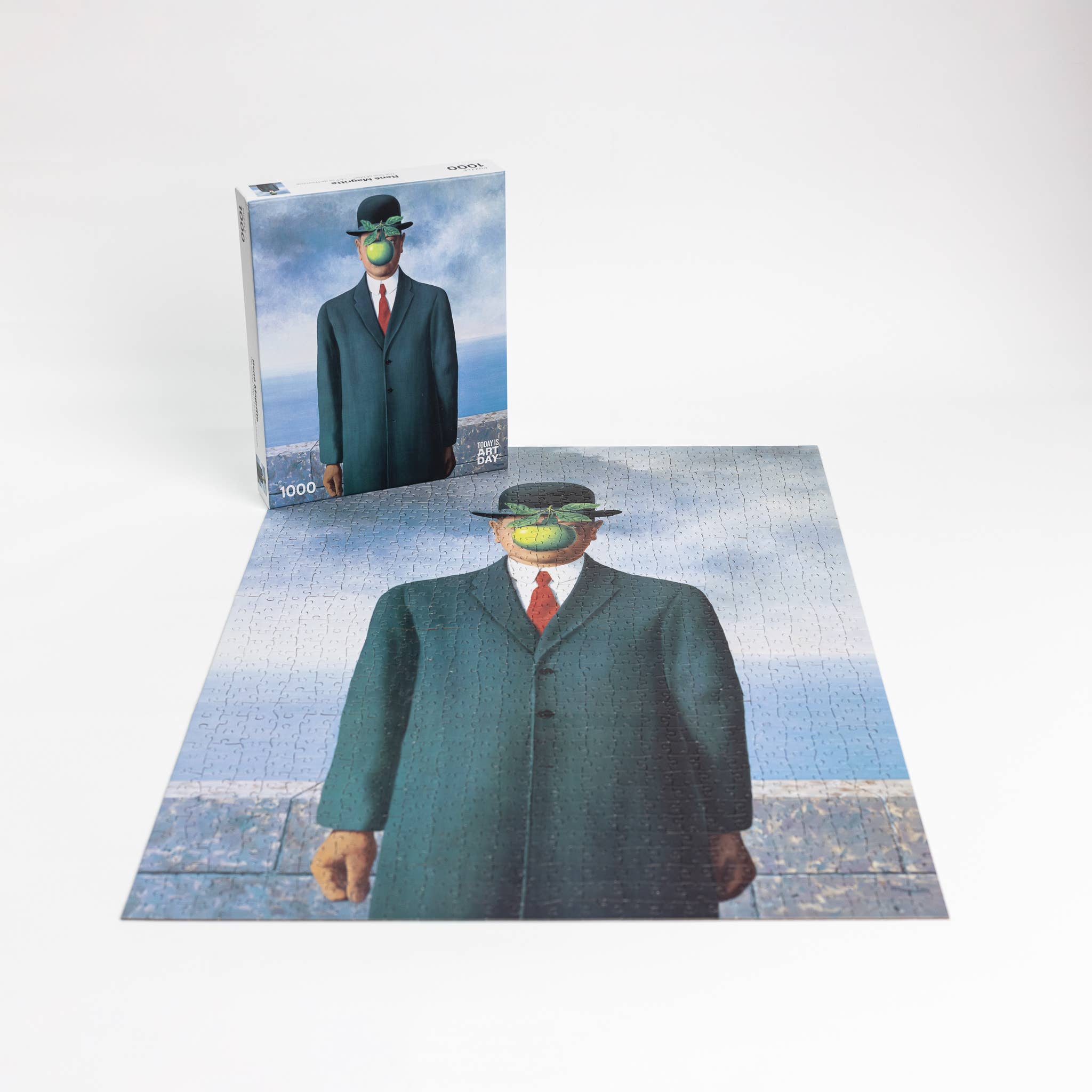 The Puzzle - René Magritte - Son of Man; suited man in a bowler hat with green apple covering his face.