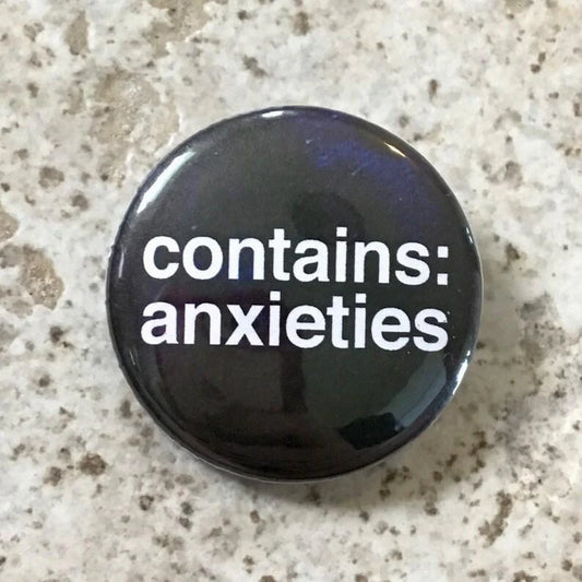 Contains Anxieties button pin, 1.25 inches, featuring white text on a speckled background.