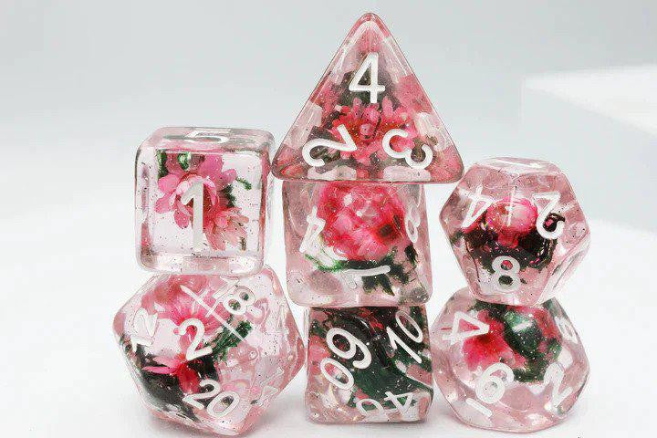 Carnation Love RPG Dice Set, clear pink polyhedral dice with embedded flowers and white numbers.