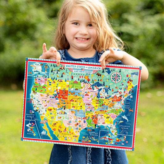 USA Map 20 Piece Puzzle held by a young girl outdoors on a sunny day.