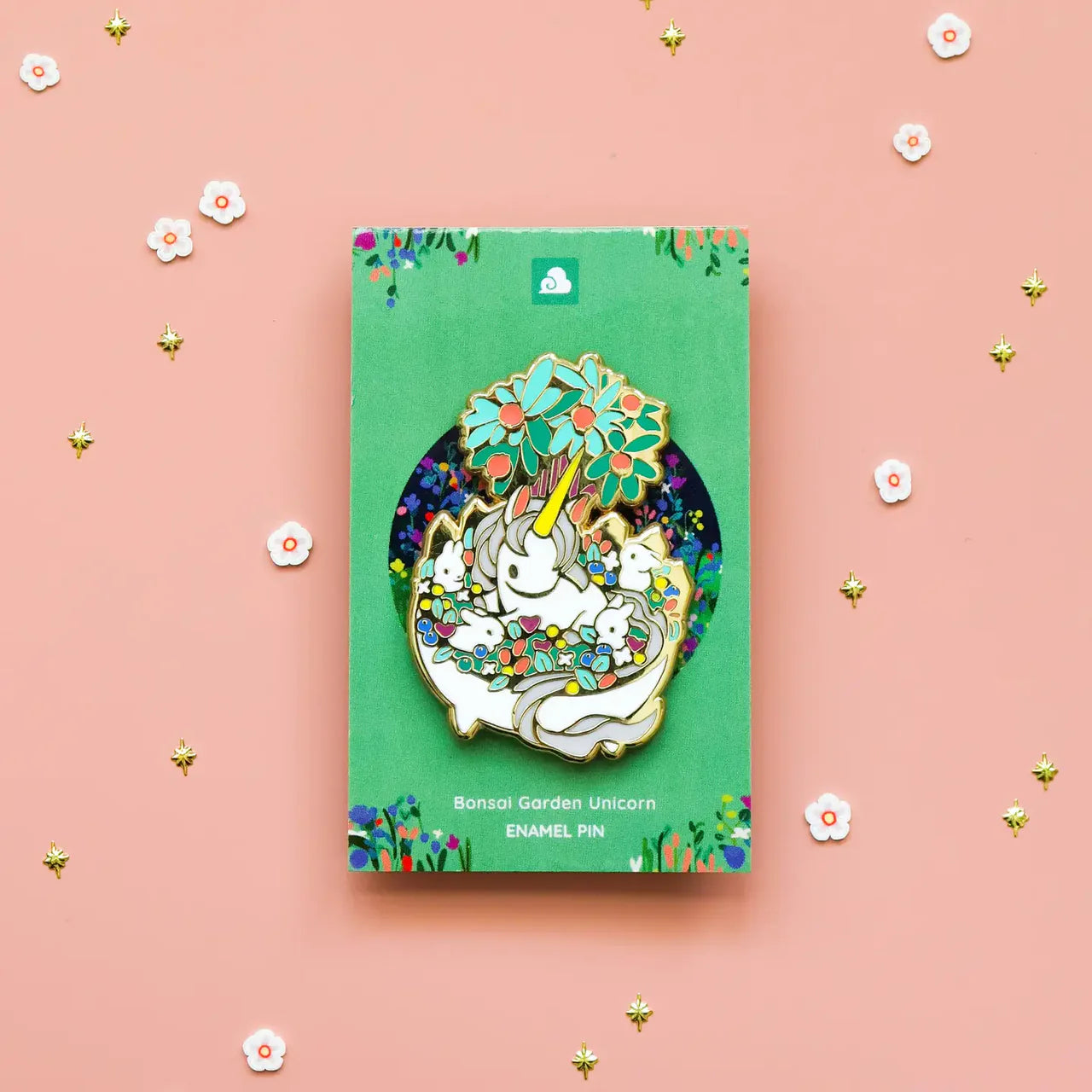 The Bonsai Garden Unicorn Enamel Pin with flower confetti accents on a green backing card.
