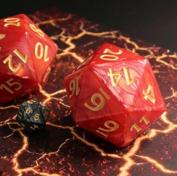 55mm Titan D20 Red Pearl and two large dice on a lava-patterned surface.