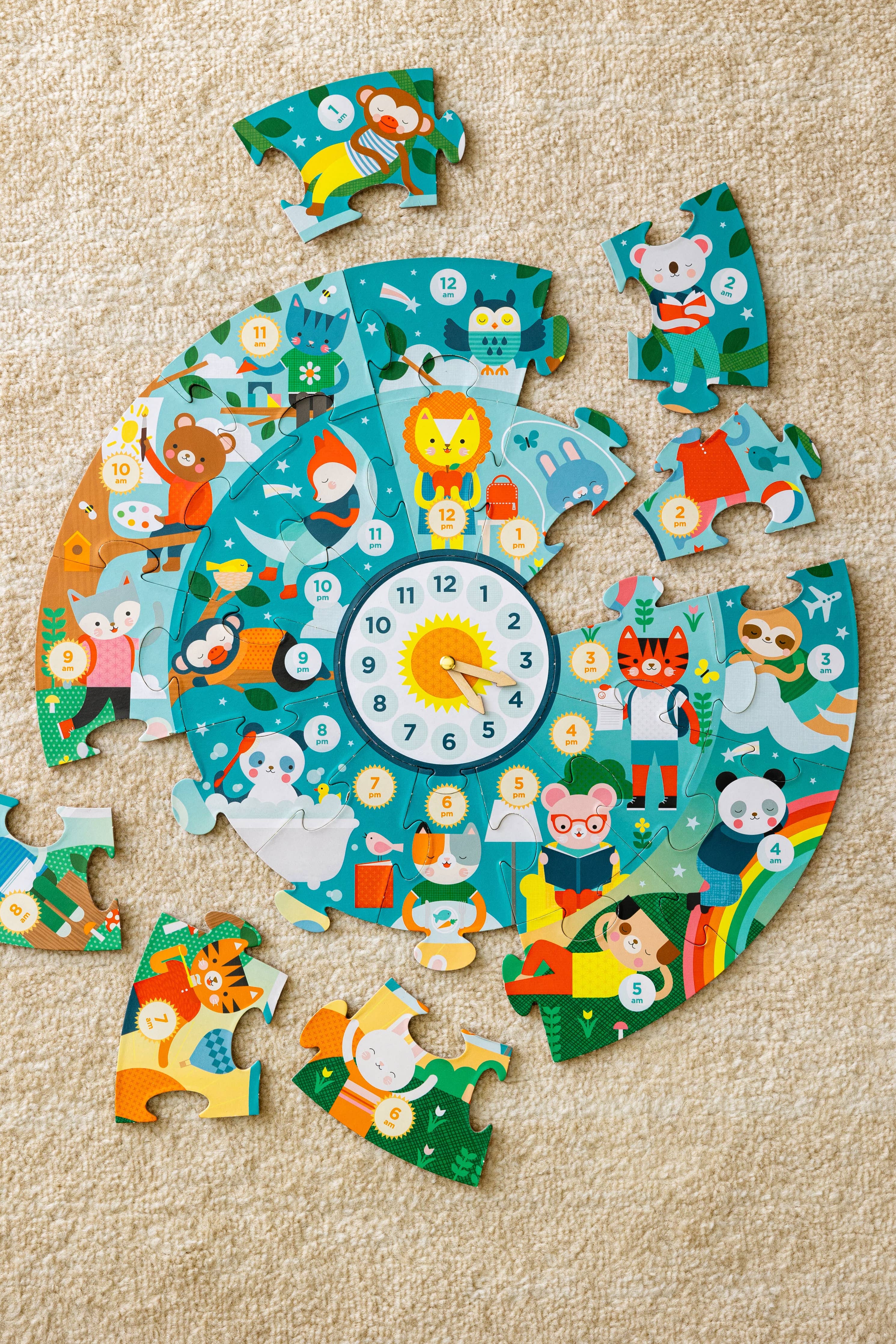 Animal-themed Telling the Time Floor Puzzle pieces, partially assembled in a circle on carpet.