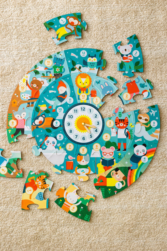 Animal-themed Telling the Time Floor Puzzle pieces, partially assembled in a circle on carpet.