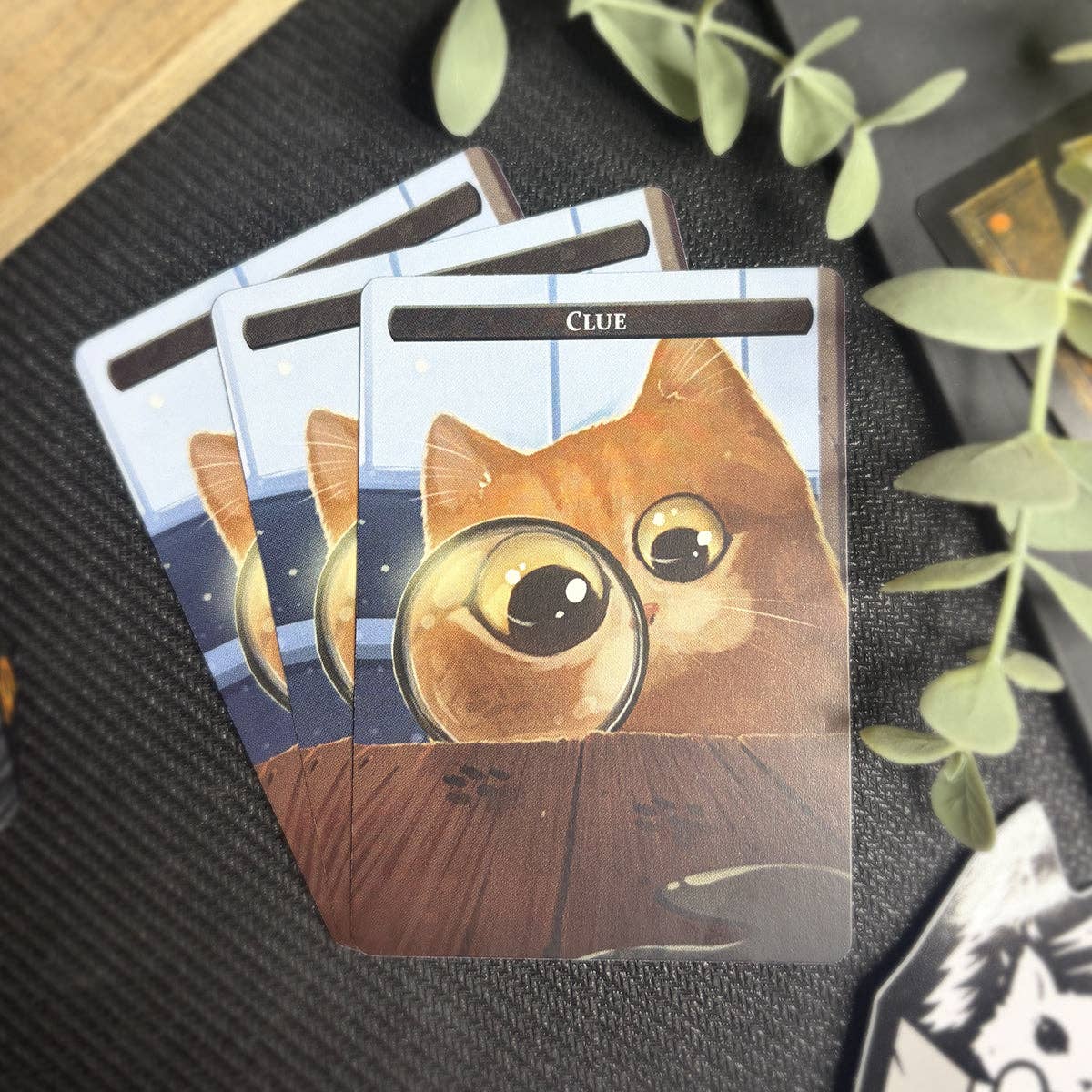 Four Thopter & Clue Token Set cards featuring an orange cat with a magnifying glass and “Clue” at the top.