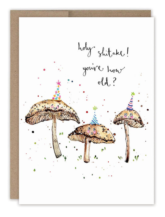 Holy Shitake Mushrooms Birthday Card with three mushrooms in party hats and text: holy shitake youre how old?.