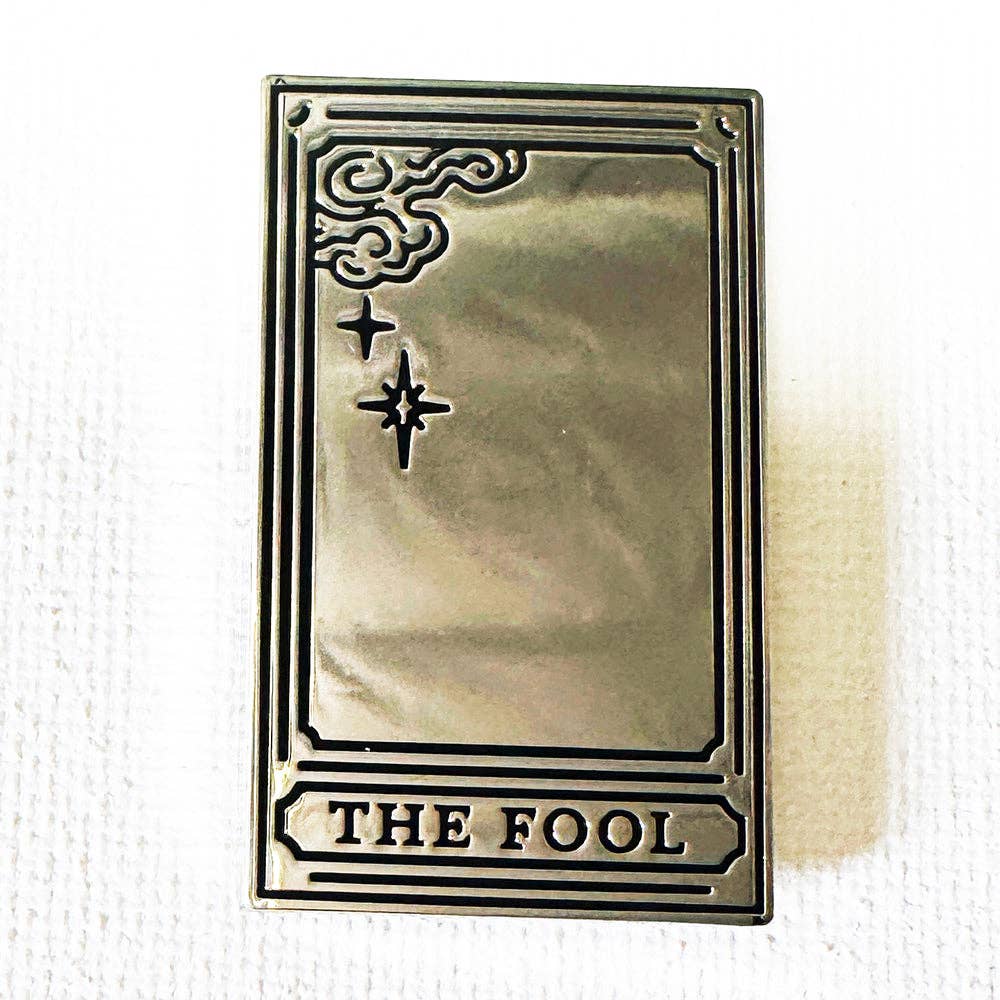 The Fool Mirror tarot card pin: a rectangular, silver-plated hard enamel pin with corner scrolls and THE FOOL text.