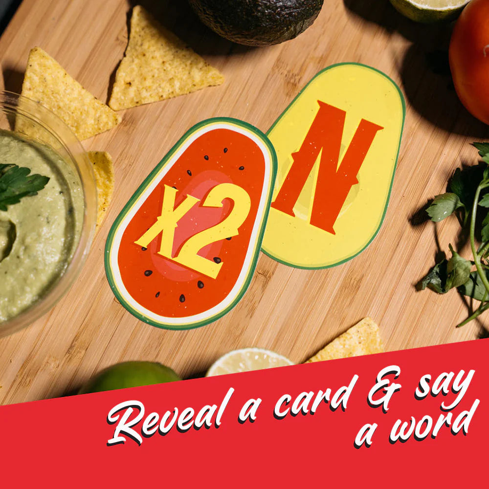 Olé Guacamole party game cards displayed on a wooden board with chips, guacamole, and vegetables nearby.