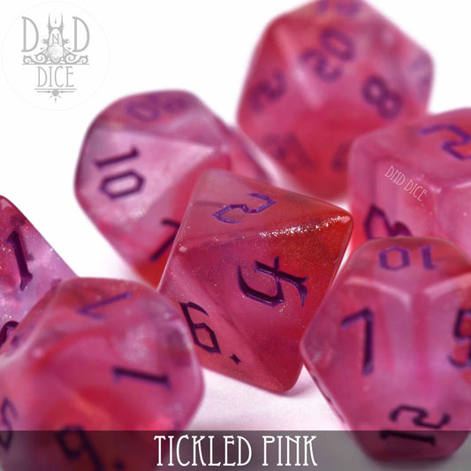 Translucent pink acrylic 7-dice set with purple numbers, labeled Tickled Pink, for DnD games.