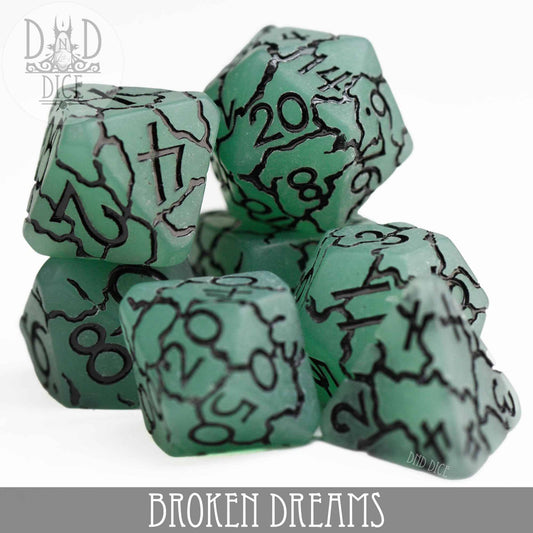 The Broken Dreams set, 7 green resin dice with black cracks and numbers.