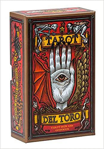Tarot Del Toro tarot deck and guidebook in a box with surreal art of a winged hand and an eye.