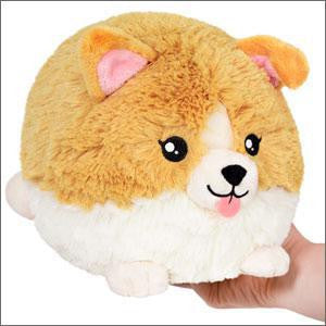 Baby Corgi 10 Mini Squishable plush with tan and white fur, large eyes, and pink ears held in a hand.