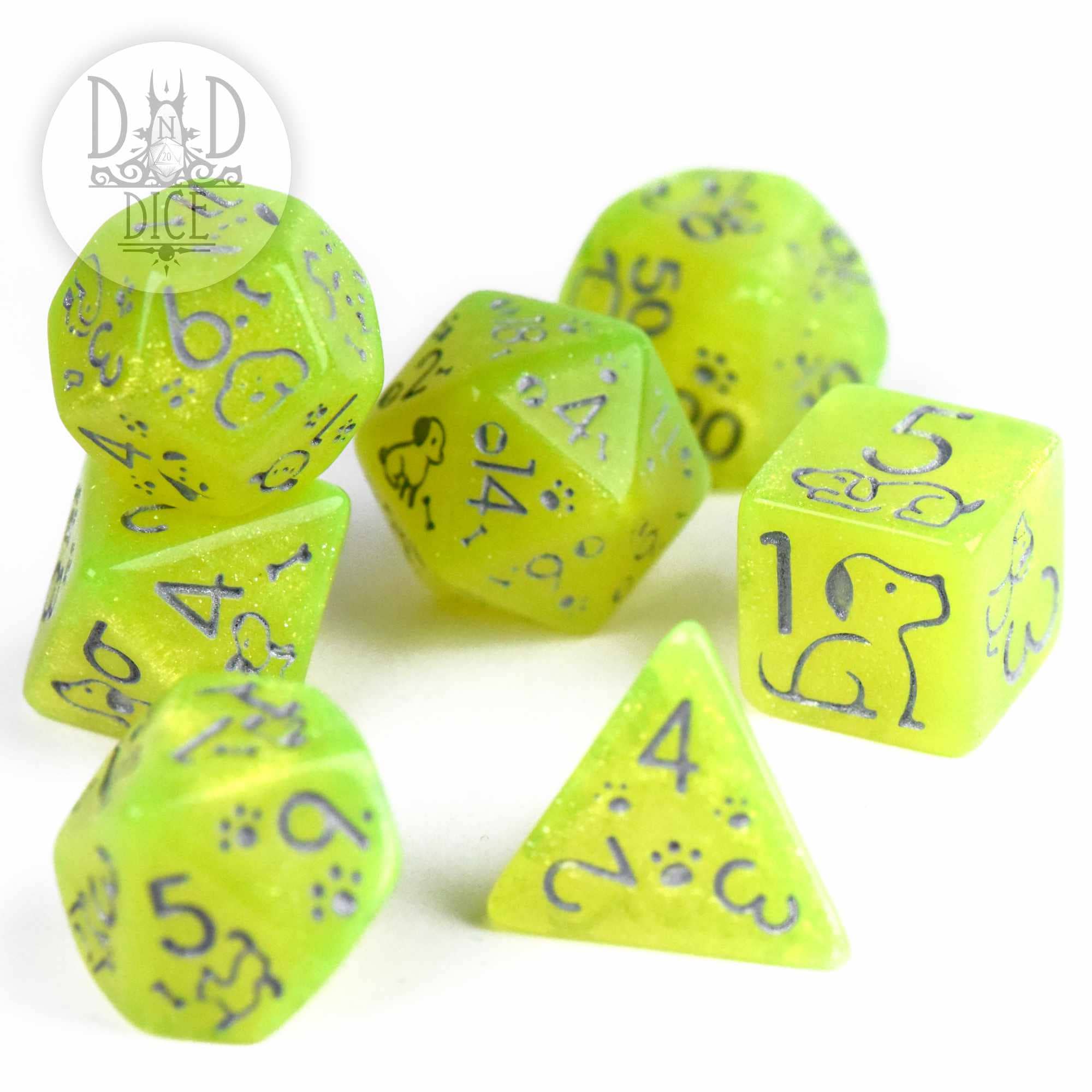 Puppers Tennis Ball 7-dice set in bright yellow-green resin with blue numbers and dog paw print designs.