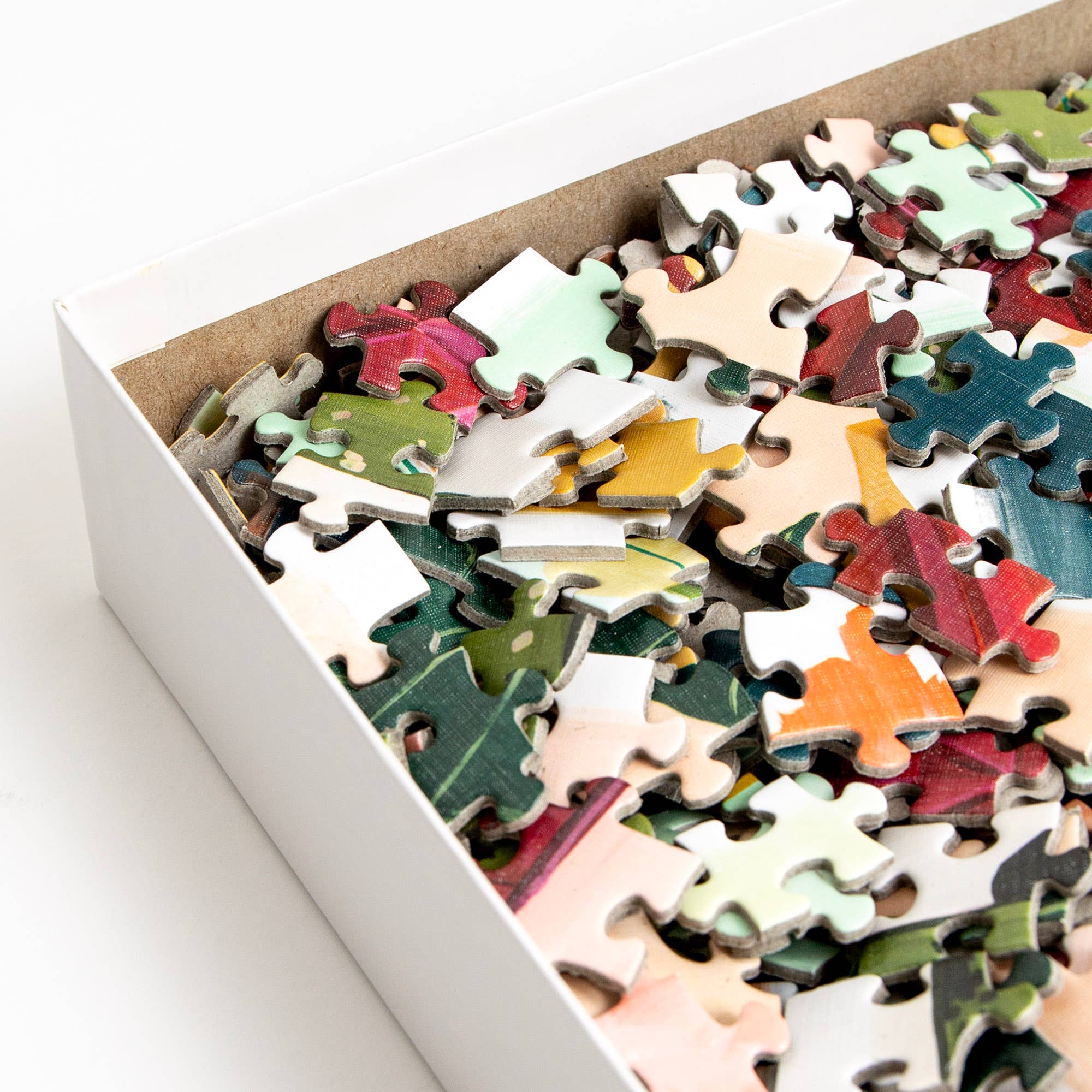 Simple Joys Puzzle, 1,000 pieces, close-up view showing colorful hand-painted illustrated pieces.