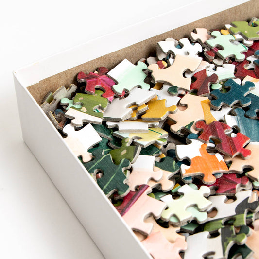 Simple Joys Puzzle, 1,000 pieces, close-up view showing colorful hand-painted illustrated pieces.