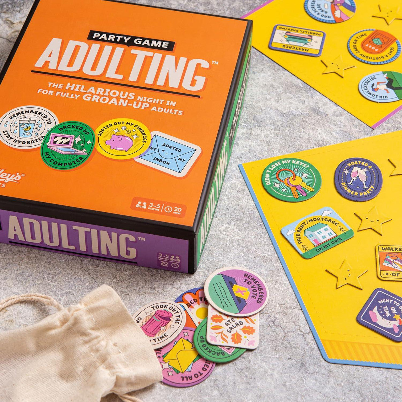 Adulting Party Game for adults with colorful tokens and cards displayed on a table.