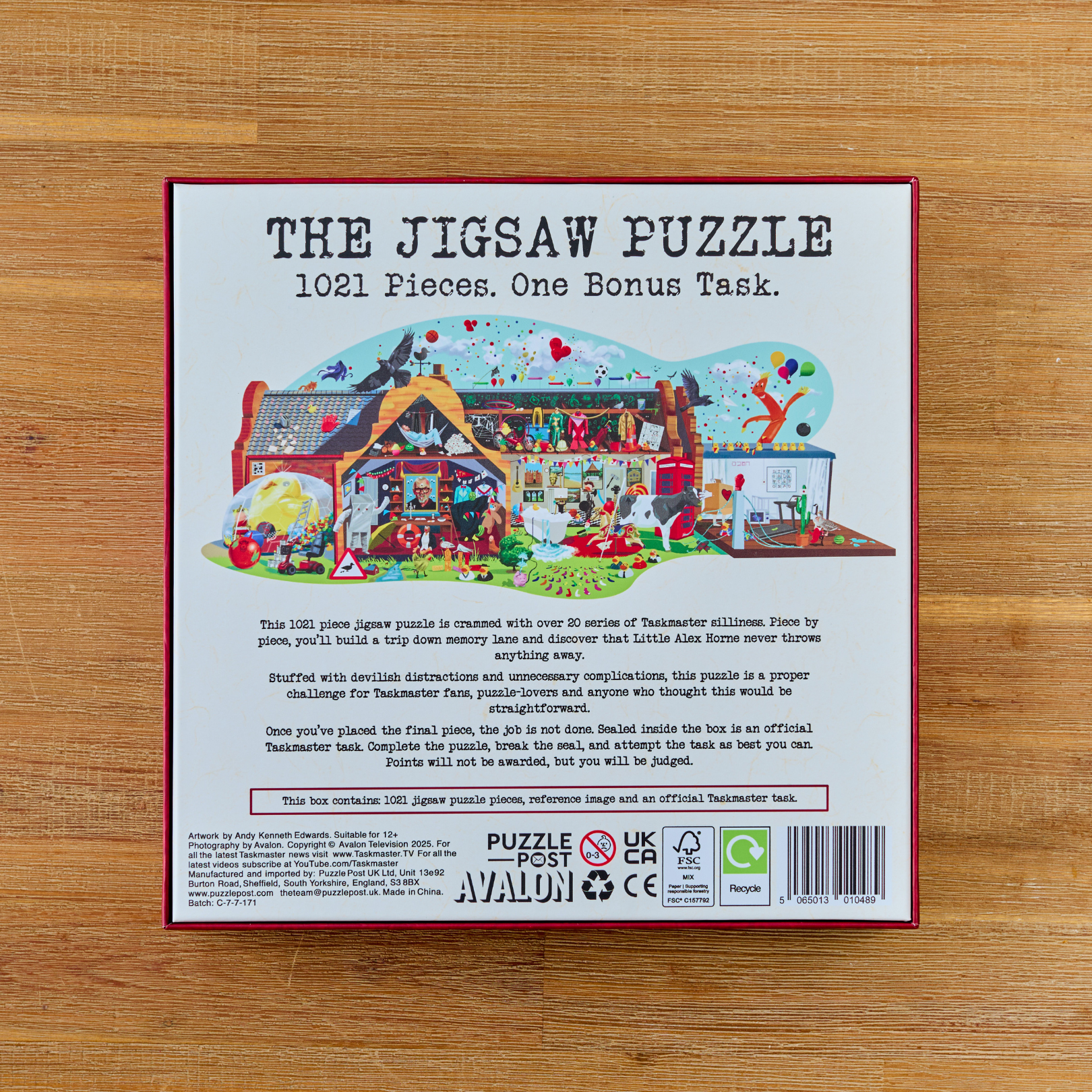 Taskmaster Jigsaw Puzzle, 1021 pieces, includes a secret task; box shows a colorful house illustration.