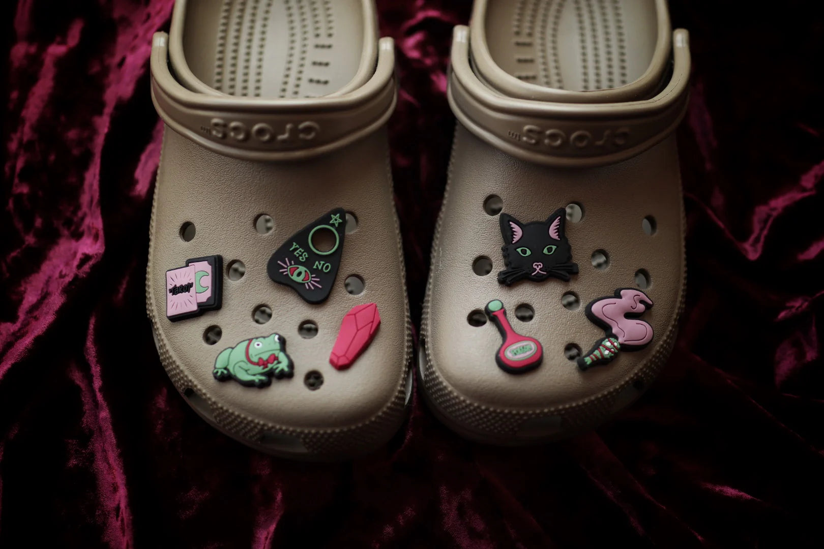 Tan Crocs with Witch Essentials II Jibbitz charms: Ouija board, tarot cards, black cat, potion, incense, psychic toad.