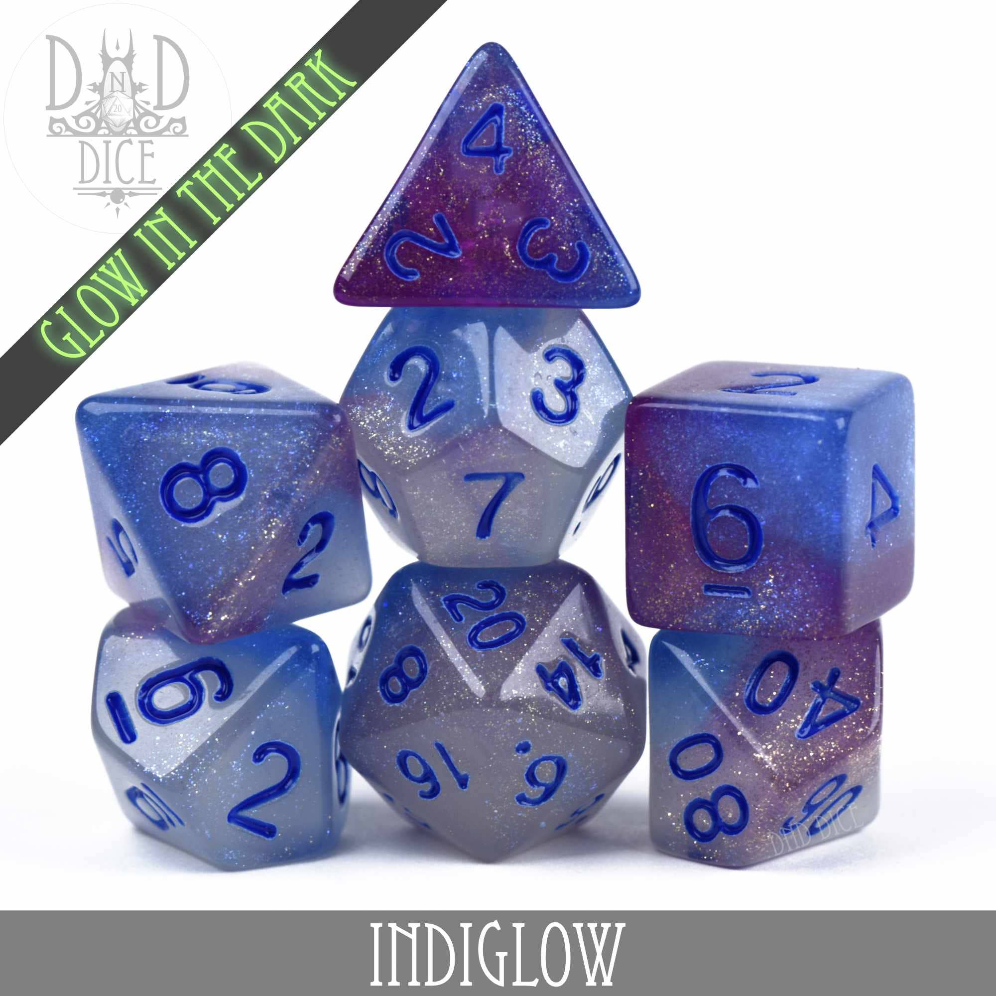 Indiglow Glow in the Dark 7-piece DND dice set in blue and purple glitter resin that glows in the dark.