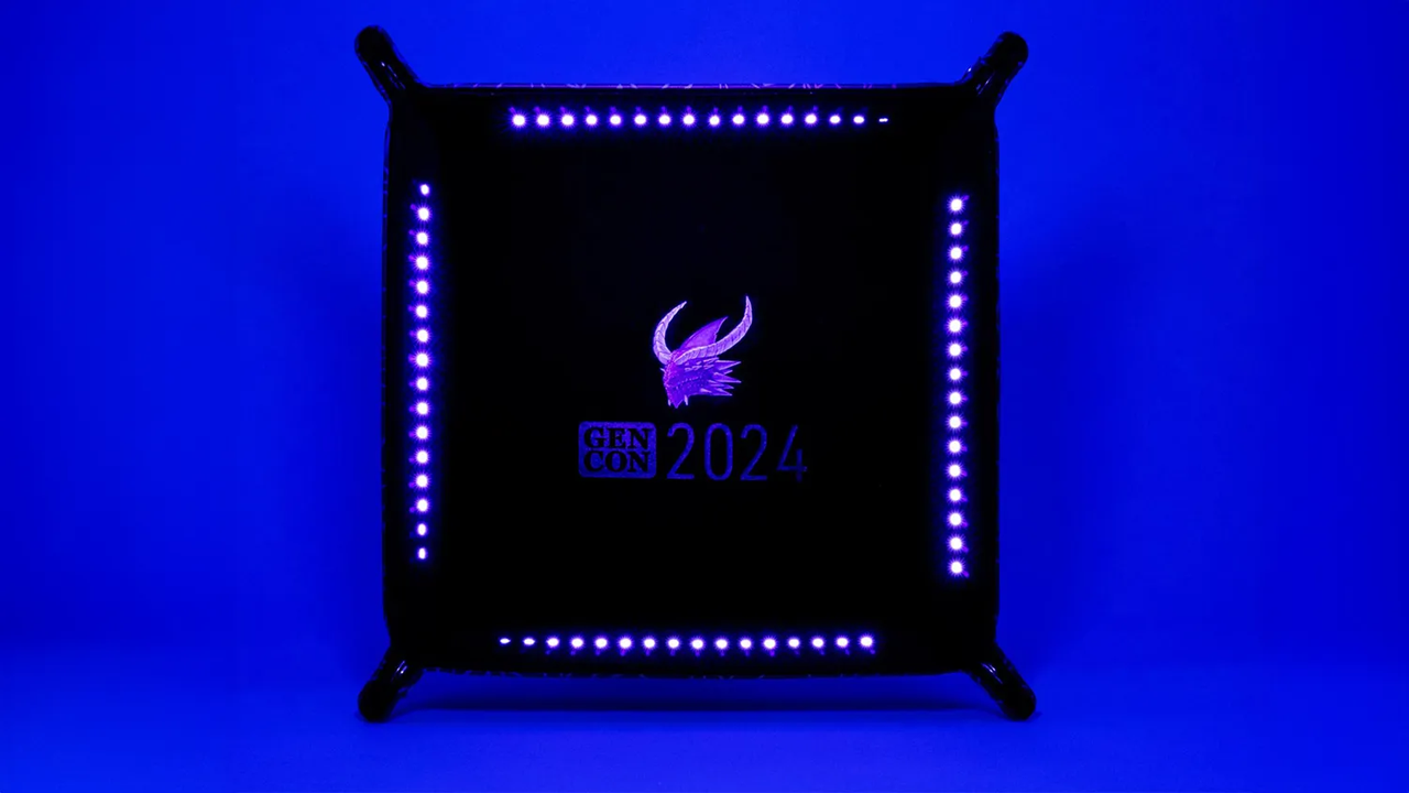 Gen Con 2024 UV Black Light Dice Tray featuring black velvet, purple LED lights, and event logo.