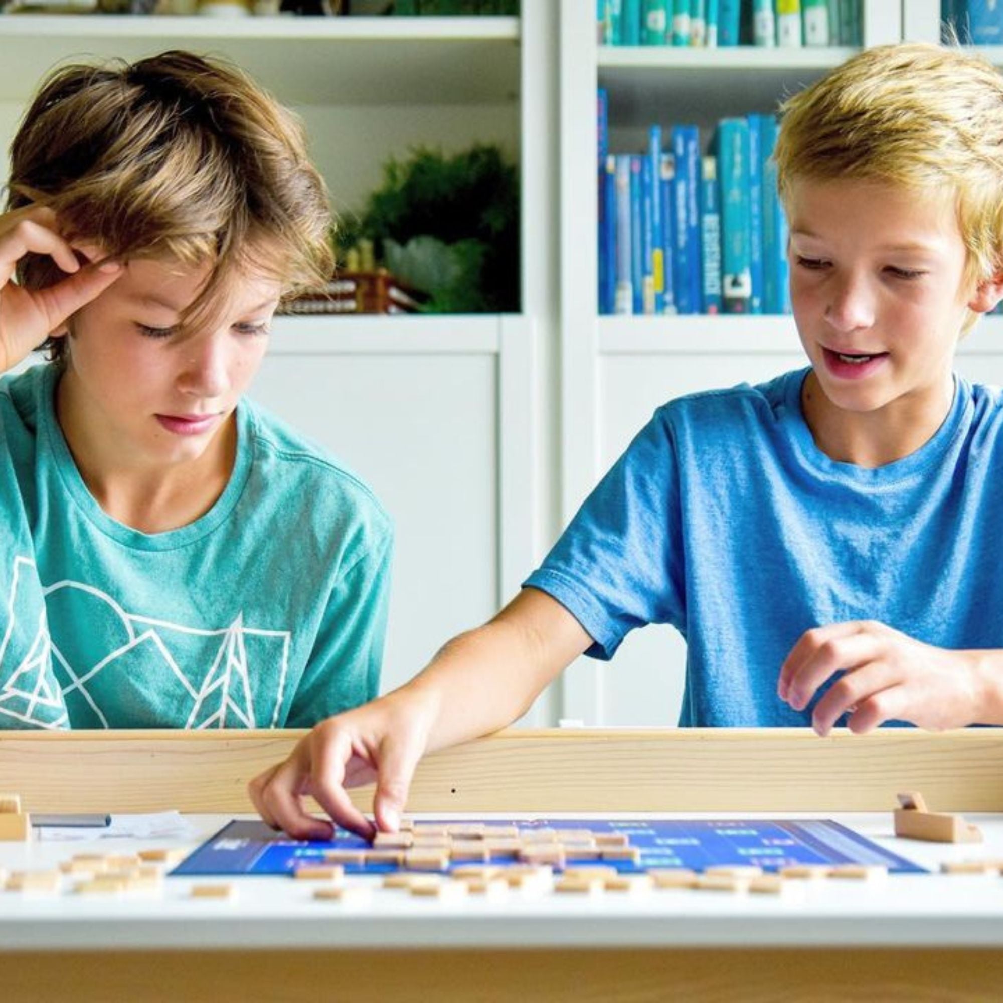 Triolet numbers tile board game being played by two boys.
