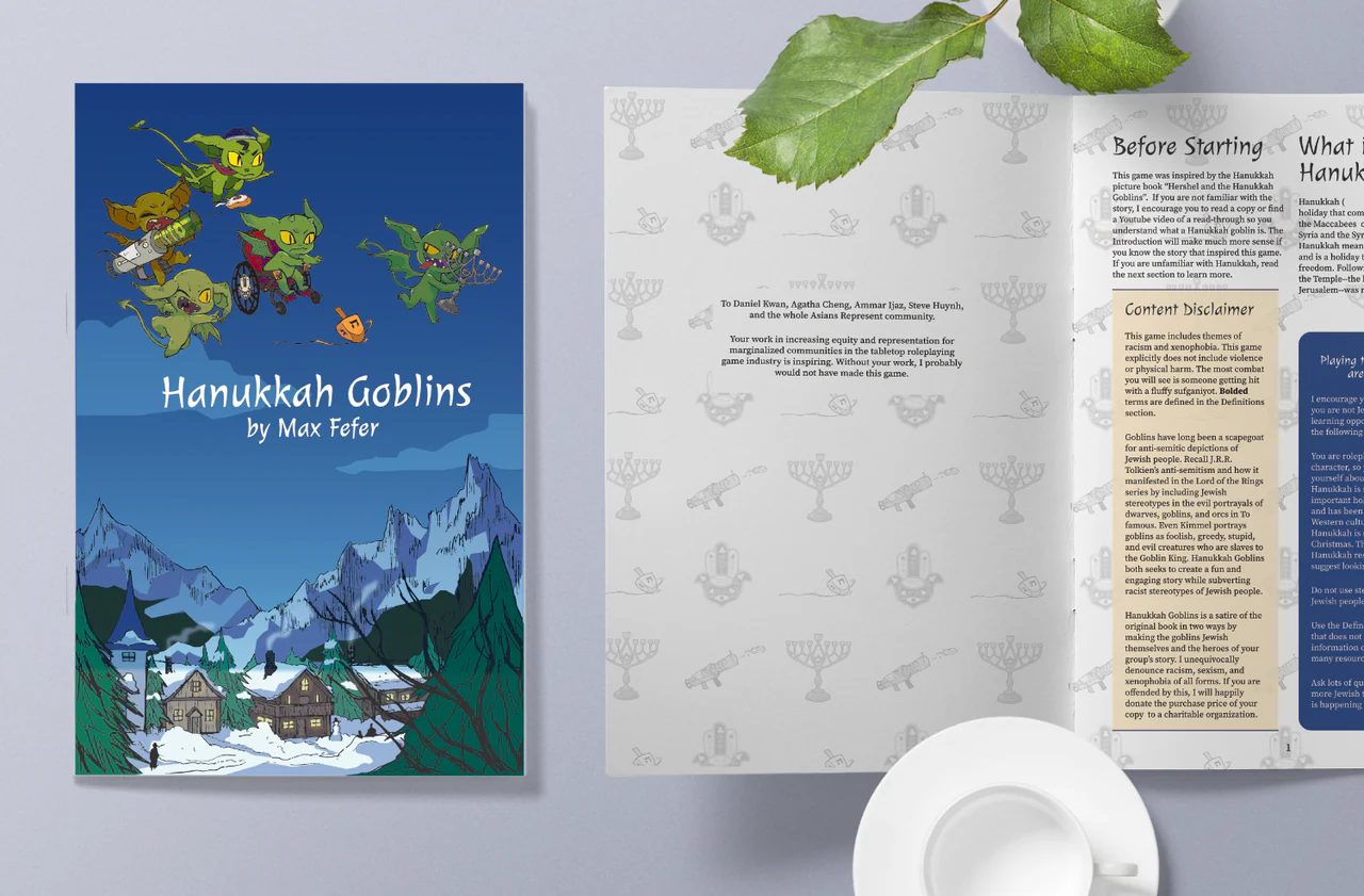 Hanukkah Goblins book displayed next to an open page, a leaf, and a teacup.