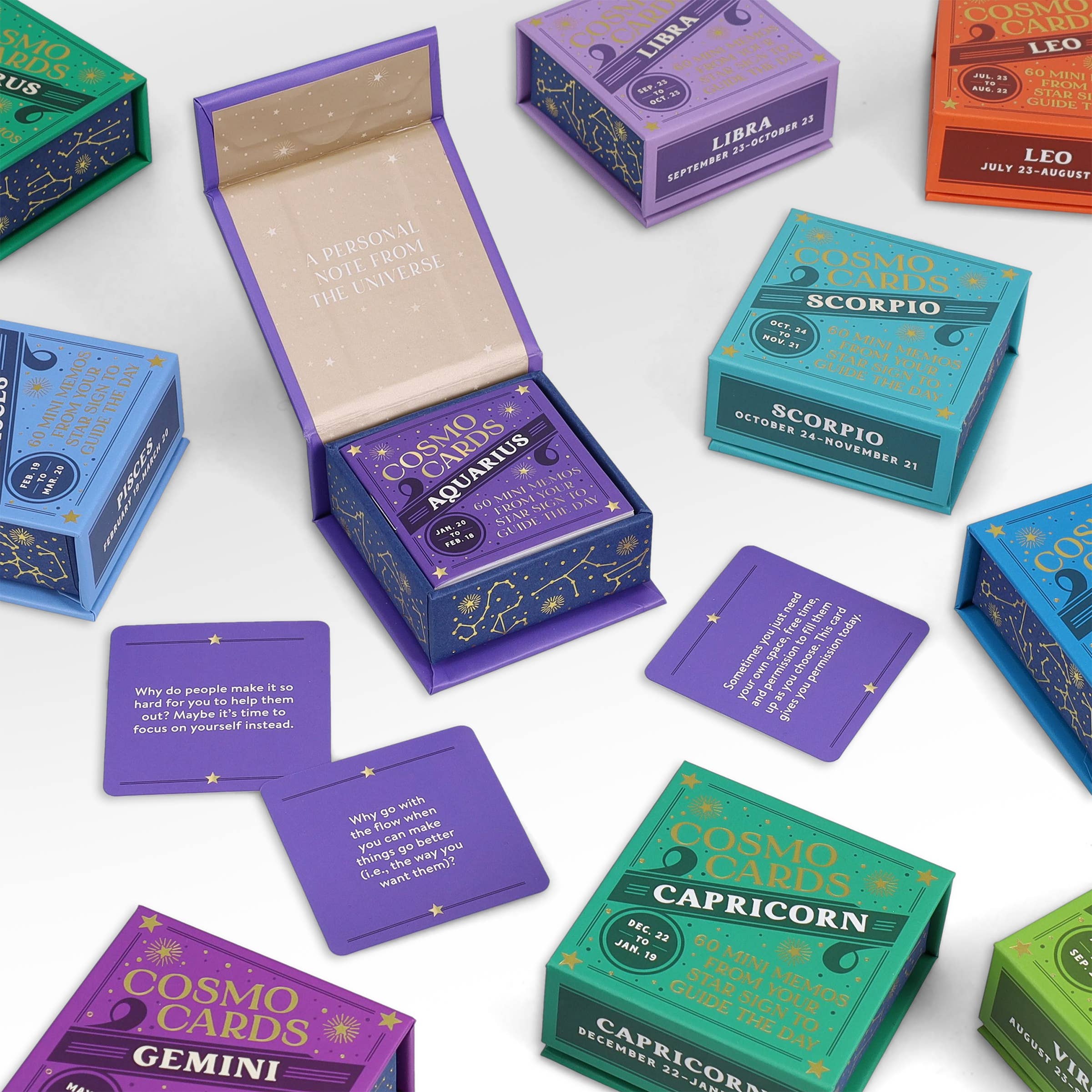 Cosmo Cards zodiac card decks: Aquarius, Gemini, and Capricorn versions displayed together.