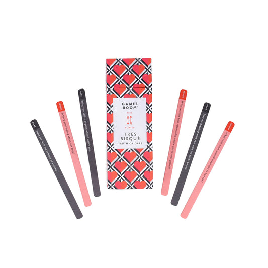 Tres Risque Truth or Dare box with seven colored sticks displayed in a semi-circle around it.