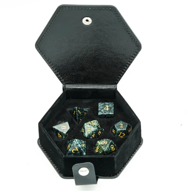 Algal Gemstone - Engraved with Gold RPG dice set from Foam Brain Games in an open hexagonal black case.