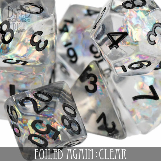 Foiled Again Clear Dice Set: 7 clear polyhedral dice with black numbers and iridescent foil.