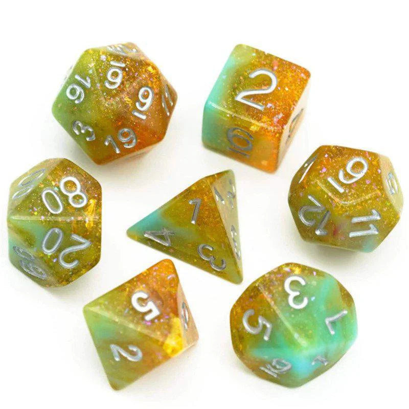 The Hobbit House RPG Dice Set includes seven multicolored glitter dice in gold, green, and blue tones for D&D games.