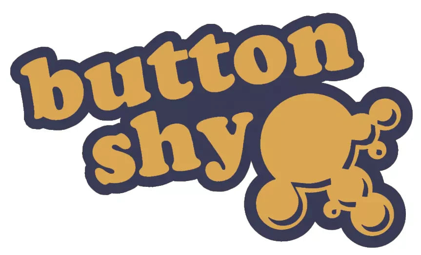 Button Shy Wallet Games logo in gold text with circular design on dark blue background.