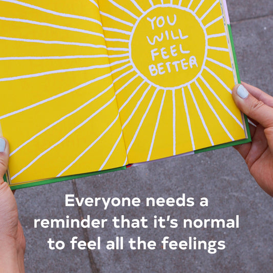 Hands hold a product labeled ‘Its OK to Feel Things Deeply’.