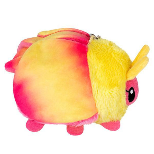 Micro Squishable Rosy Maple Moth plush with yellow and pink fur, black eyes, and a metal attachment clip.