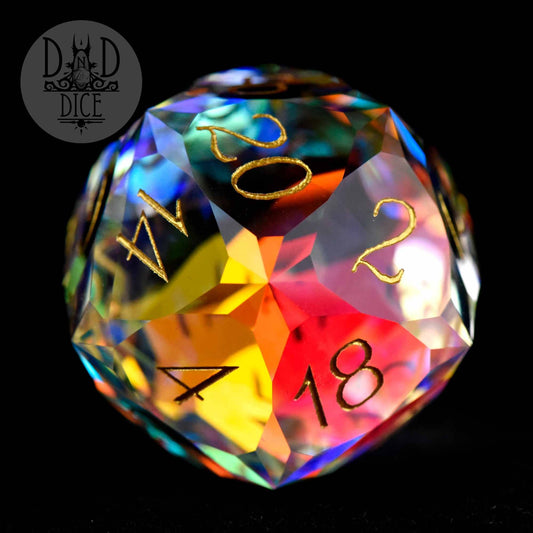Multicolored faceted glass 30mm D20 with gold numbers, shown in a gift box.