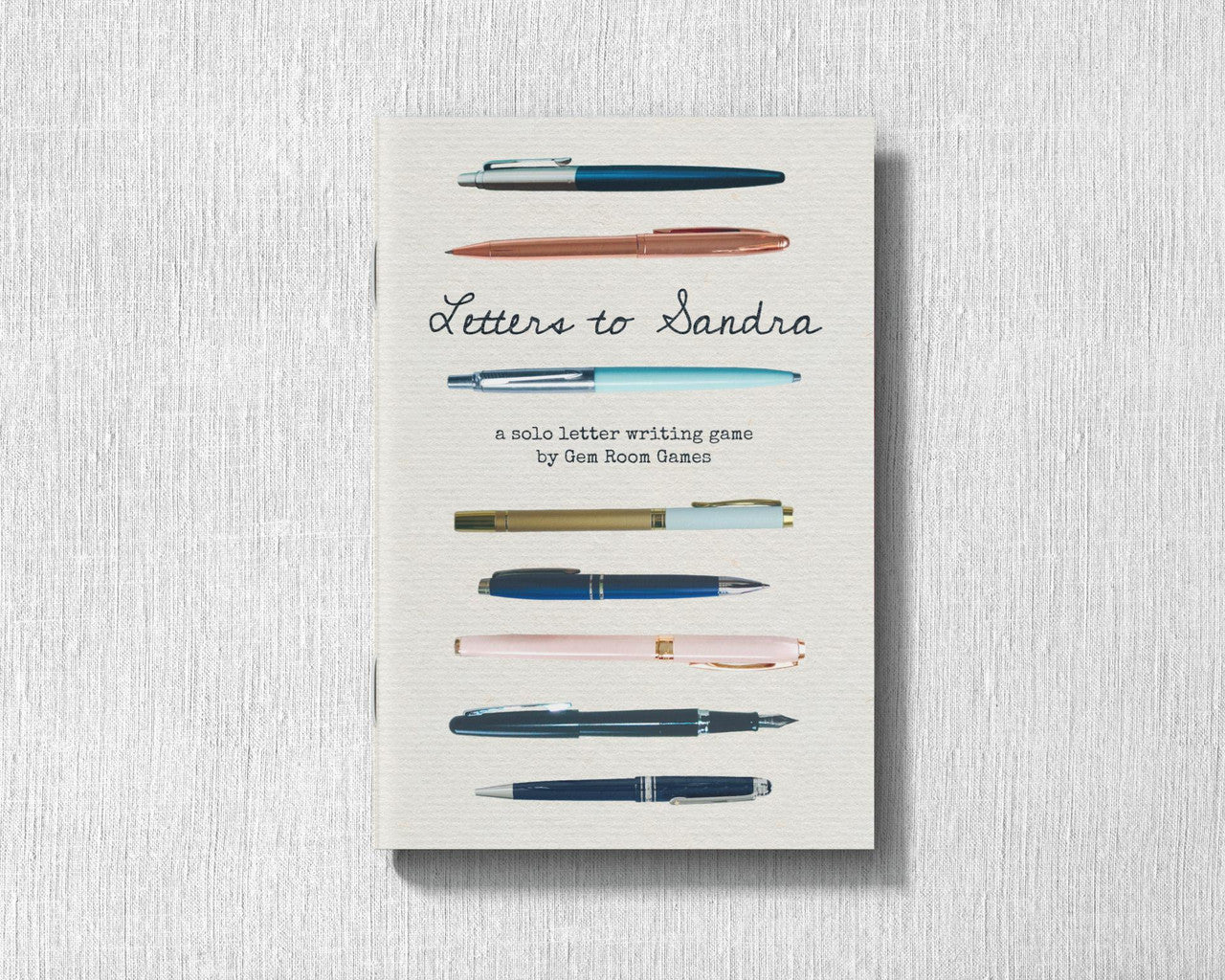 Letters to Sandra - A Solo Letter-Writing Game cover with seven pens and references to communication and betrayal.