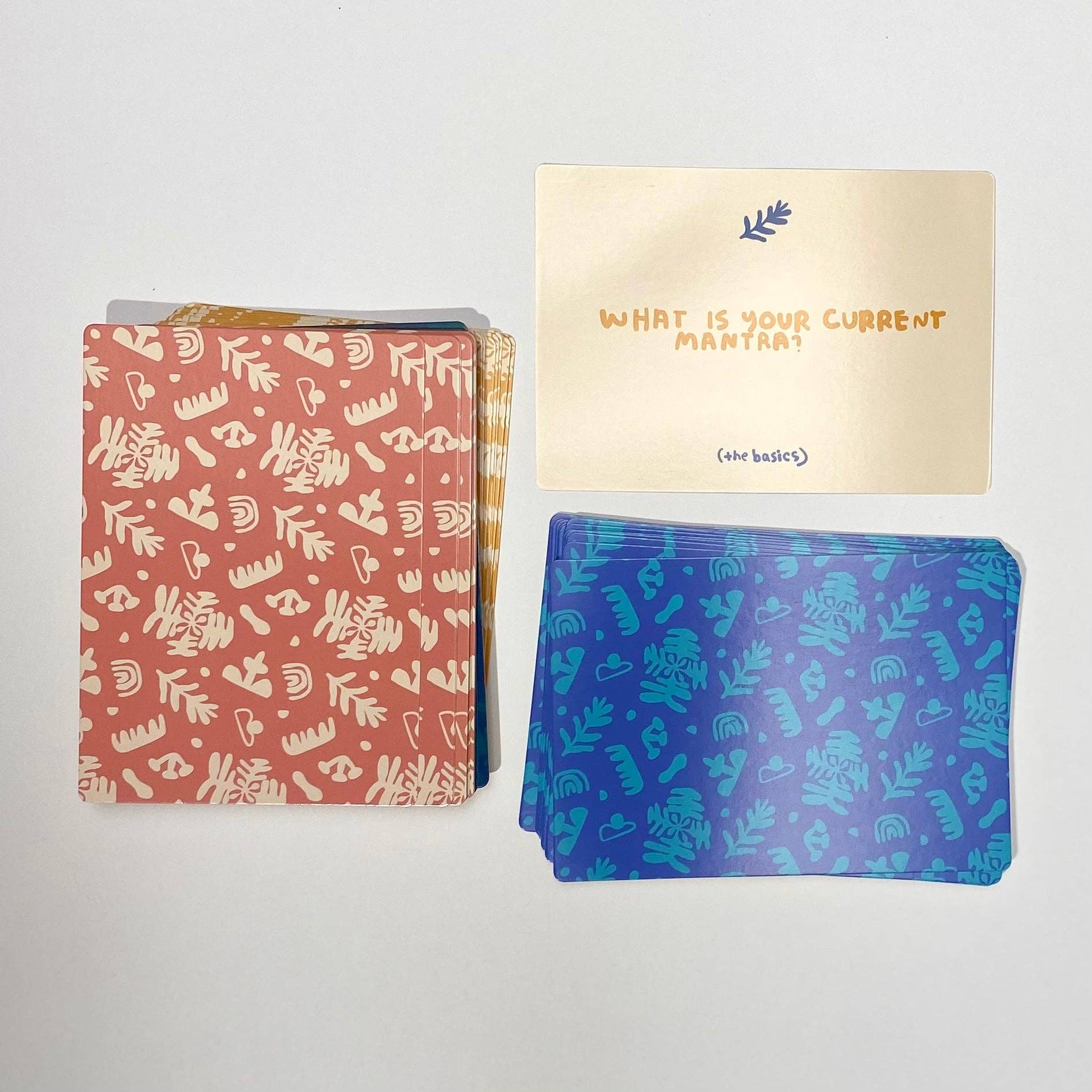 A Safe Space For Us Deck with three stacks of prompt cards featuring questions like What is your current mantra?.