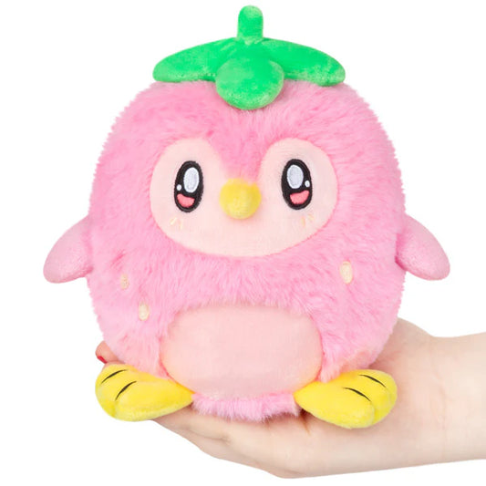 Strawberry Penguin Alter Ego Squishable, a small pink plush bird with yellow feet and a green leaf, held in a hand.