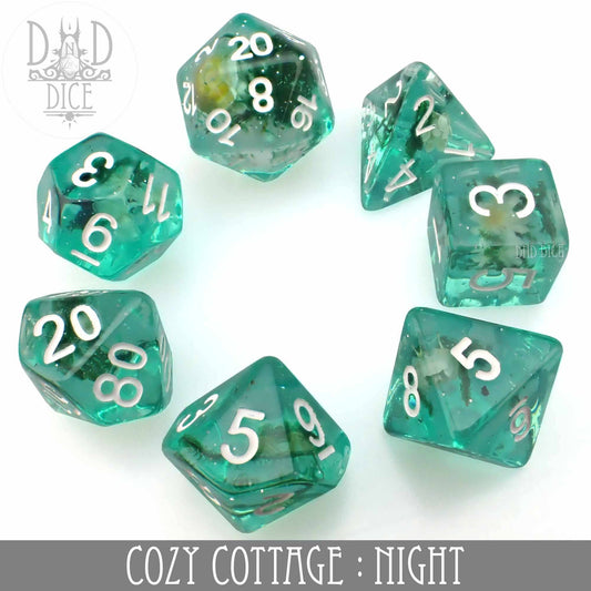 Cozy Cottage Night: set of 7 green resin polyhedral dice with white numbers on a white background.