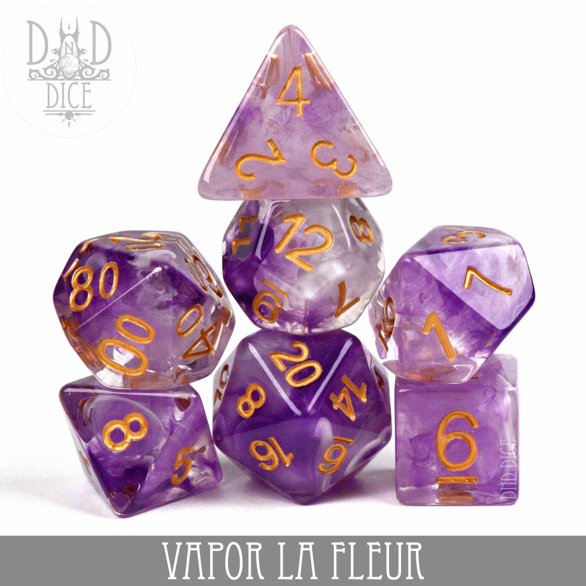 Vapor La Fleur 7-piece dice set in purple and clear resin with gold numbers.