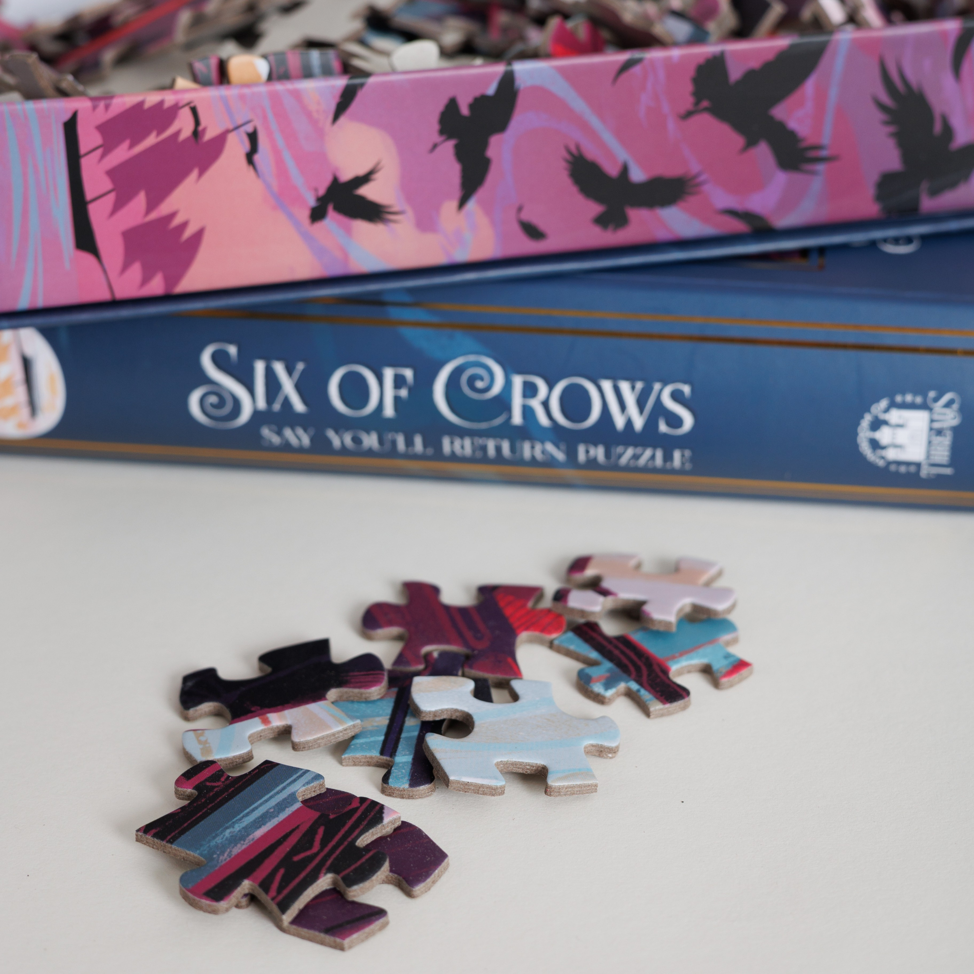 Say You’ll Return Keepsake Puzzle | Six of Crows, with puzzle pieces and a book-shaped box featuring crow art.