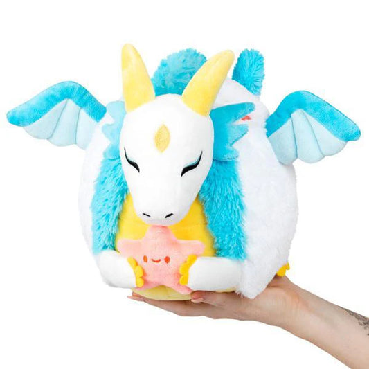 Mini Wish Dragon with blue wings, yellow horns, and a pink star displayed on an open hand.