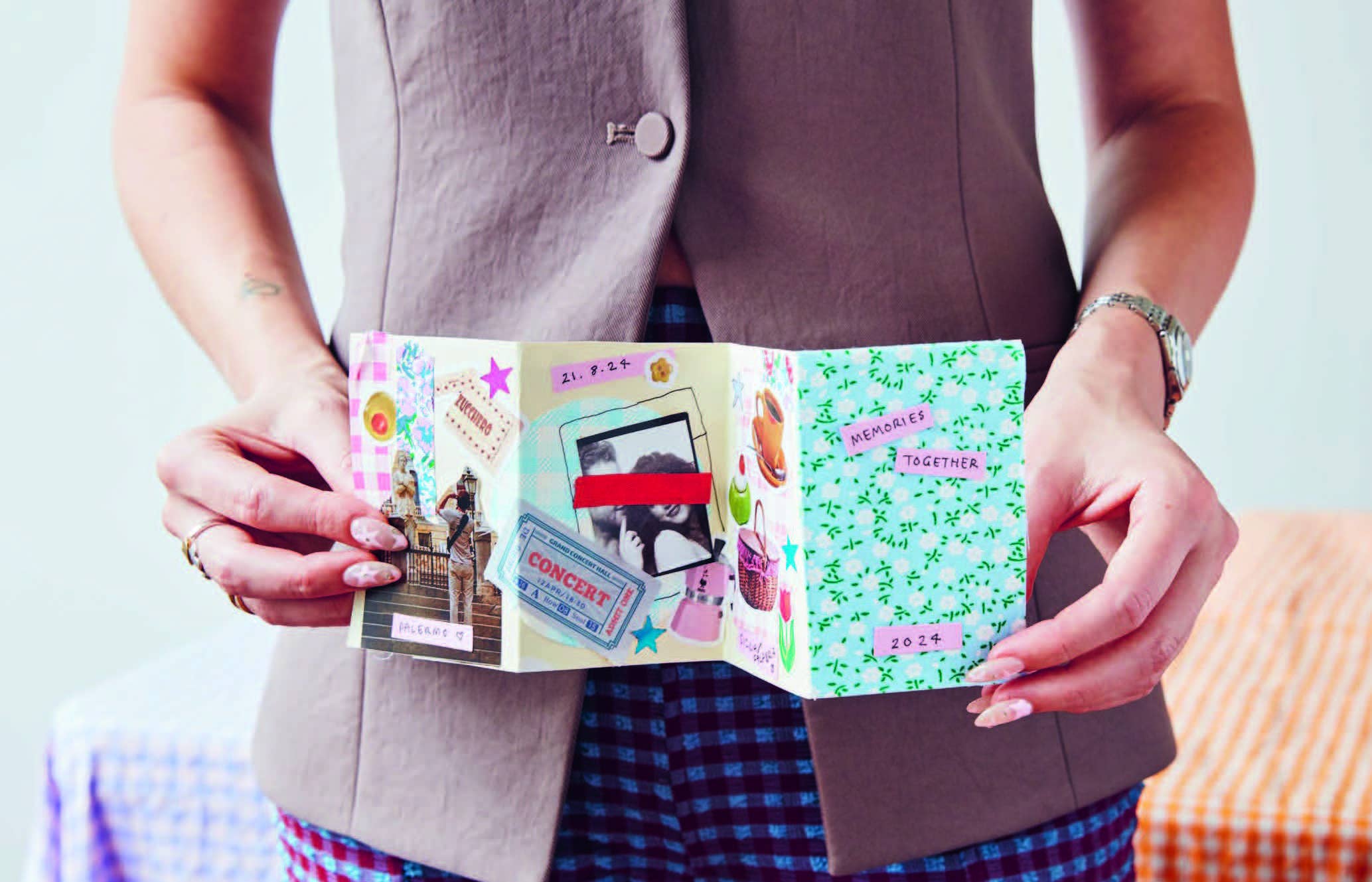 Person holding The Art of Memory Collecting handmade scrapbook for memory keepsakes.