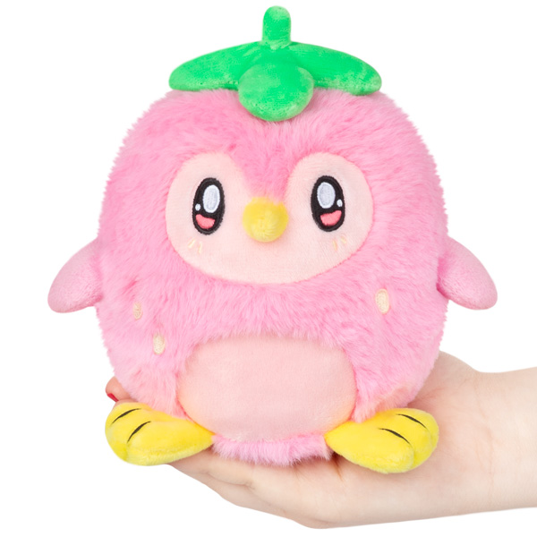 Strawberry Penguin Alter Ego Squishable, a round pink plush with green leaf, yellow feet, and simple face held in a hand.