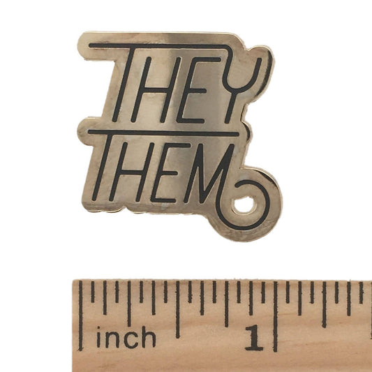 They/Them Pronoun Pin shown beside a ruler, approximately 1 inch wide.